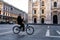 Single man on bicycle riding in empty square of Milan`s Cathedra