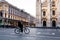 Single man on bicycle riding in empty square of Milan`s Cathedra