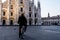 Single man on bicycle standing alone in front of Milan`s Cathedr