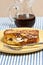 Single, maple bacon, stuffed French toast on yellow, round plate