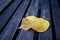 Single maple leaf in wooden bench