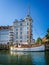 Single masted wooden sailing boat in the canal in the Nyhavn district of Copenhagen, Denmark