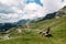 Single millenial man sits on a bench on a mountain plateau and looks at the mountains in front of him. Montenegro, Durmitor.