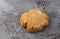 Single molasses cookie on gray mottled background