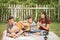Single mom and sons play guitar together in the park