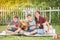 Single mom and sons play guitar together in the park
