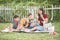 Single mom and sons play guitar together in the park