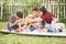 Single mom and sons play guitar together in the park