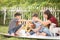 Single mom and sons play guitar together in the park