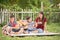 Single mom and sons play guitar together in the park