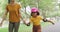 Single mother skating with her adopted daughter in park. Young smiling parent enjoying free time with her adorable girl