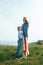 Single mother with son on independence day of USA. Woman and her child walk with the USA flag on the ocean coast