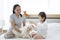 A single mother with a young child ties the hair to a white-haired maltese dog. Baby Grooming for white dog