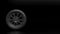 Single new car wheel isolated on a black background. Mock up for advertising car service or auto maintenance. Copy space for text
