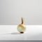 A single onion sitting on a white surface. AI generative image.