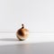 A single onion sitting on a white surface. AI generative image.