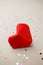 Single origami Red paper Valentines Day heart and party confetti on gray background, valentine mother birthday day close up