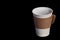 Single paper takeaway cup of coffee on absalutly black
