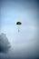 Single parachute jumper against blue sky background