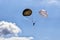 Single paratrooper with pair of vintage parachutes