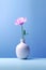 A single pink flower in a white vase. Generative AI image.