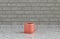 Single pink porcelain coffee mug on a front view kitchen counter top with gray tiled brick wall, 3d Rendering, close-up view
