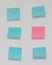 Single pink post it note in sea of blue post notes