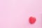 Single Pink Valentine`s day heart shape candy on empty pastel pi