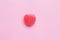 Single Pink Valentine`s day heart shape candy on empty pastel pink paper background. Love Concept. top view. Minimalism colorful