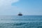 Single pirate schooner among blue water off the coast of Alanya Turkey. One tourist ship on the horizon. Background with copy