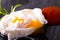 Single poached egg on slate stone with ketchup