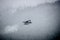Single Prop Airplane Pontoon Plane flying through fog over Alaska Last Frontier
