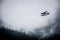 Single Prop Airplane Pontoon Plane flying through fog over Alaska Last Frontier