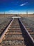 A single railroad track cutting through Northern California fields.