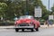 A single red american vintage car cabriolet drives on the road in Havana City