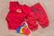 Single red baby bodysuit with plastic toy keys