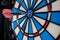 Single red dart on dartboard bullseye. Victory concept