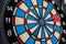 Single red dart on dartboard bullseye. Victory concept