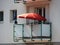 Single Red Parasol on Balcony in Apartment Building