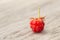 Single Red Ripe Raspberry On Wood Table