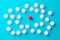 Single red sphere in the middle of group or team of white spheres over blue background, team, leadership or individuality concept