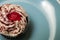 Single red velvet cupcake on a blue plate