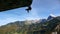 Single rock climber on a giant overhanging roof with great mountain panorama