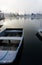 Single rowing boat on glassy-still waters