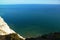 A single sail on the sea, South England cliffs, UK