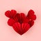 Single saturated red paper heart in oriental origami style of many little hearts on pink background, top view, square.