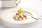 single serving of waldorf salad with a fork on a porcelain dish