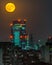 A single shoot of the full moon in Milan by night cityscape
