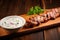a single skewer of yogurt marinated grilled kebab on a wooden table