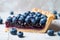 Single slice of blueberry fruit tart